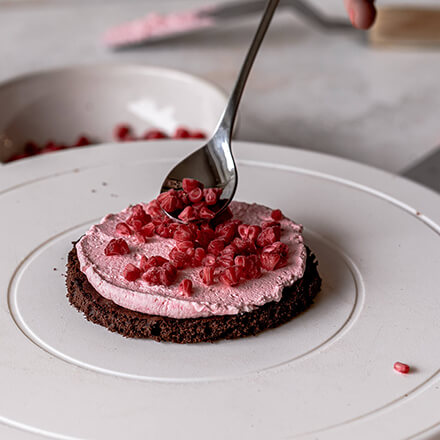 Valentinstag-Torte: Himbeeren auf die Creme geben Schicht Himbeeren wird aufgetragen