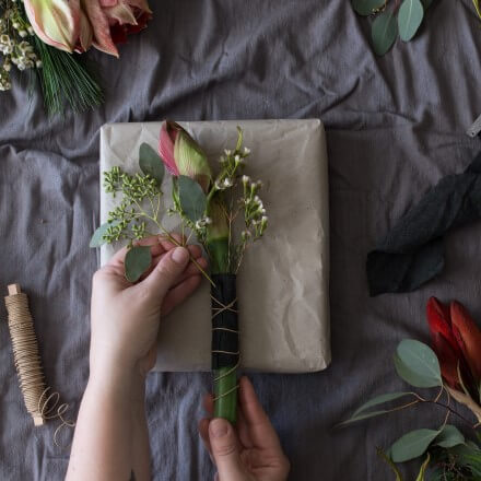 Geschenkverpackung mit Amaryllis dekorieren Amaryllis wird auf der Geschenkverpackung arrangiert